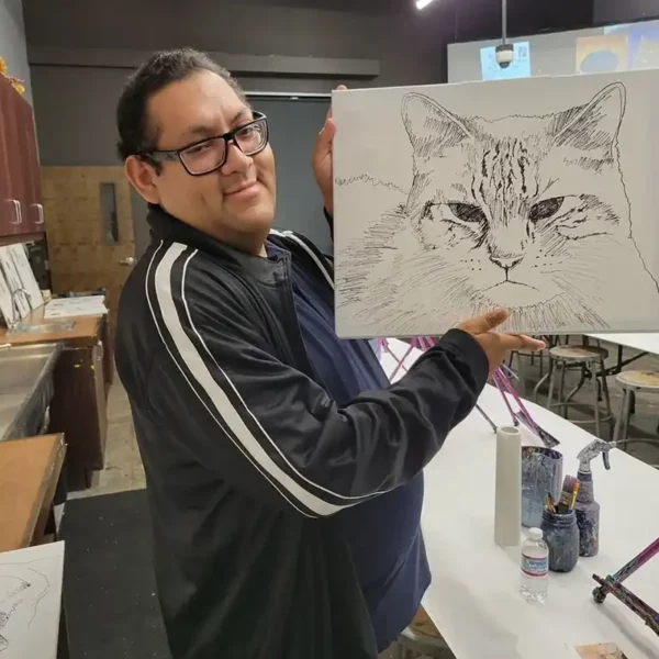 Staff holding drawing of a cat