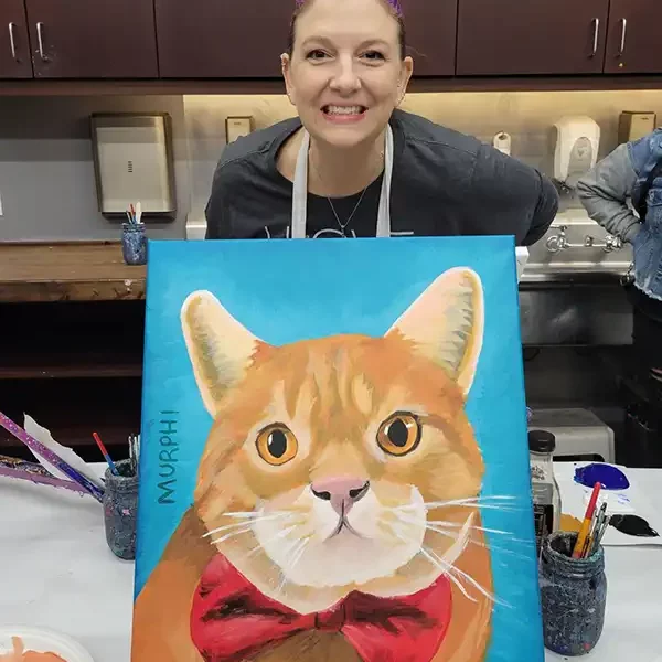 Murphi holding painting of cat