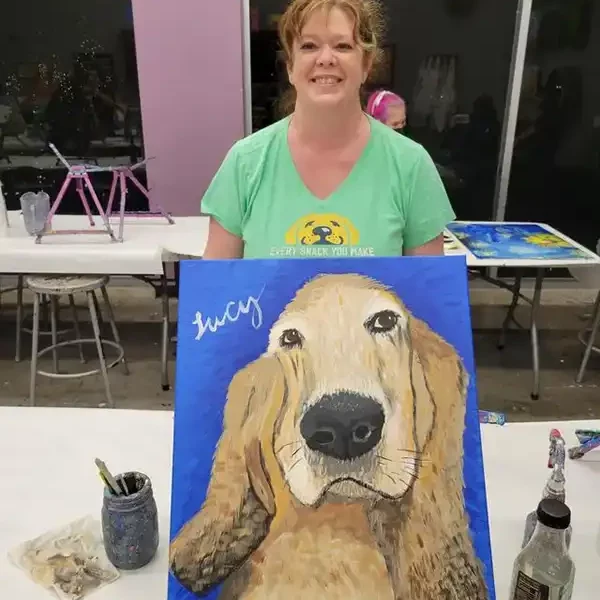 Lucy holding painting of dog